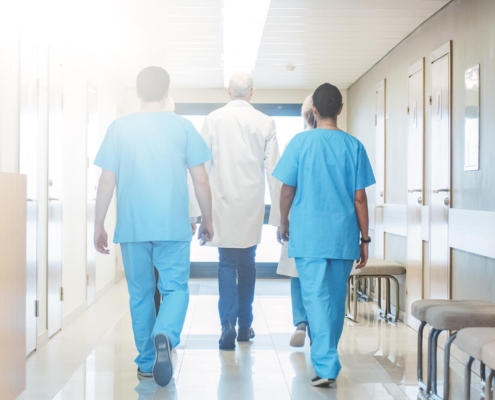 Back view of a group of medical professionals walking togather