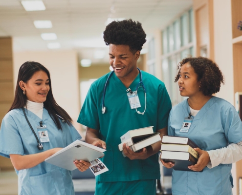 A group of nursing students walking in the library