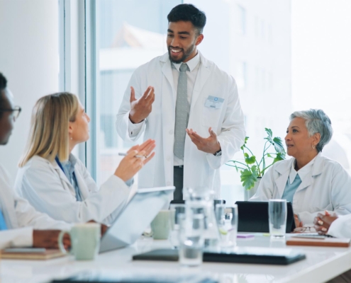 Front view of a group of physicians sitting in a meeting